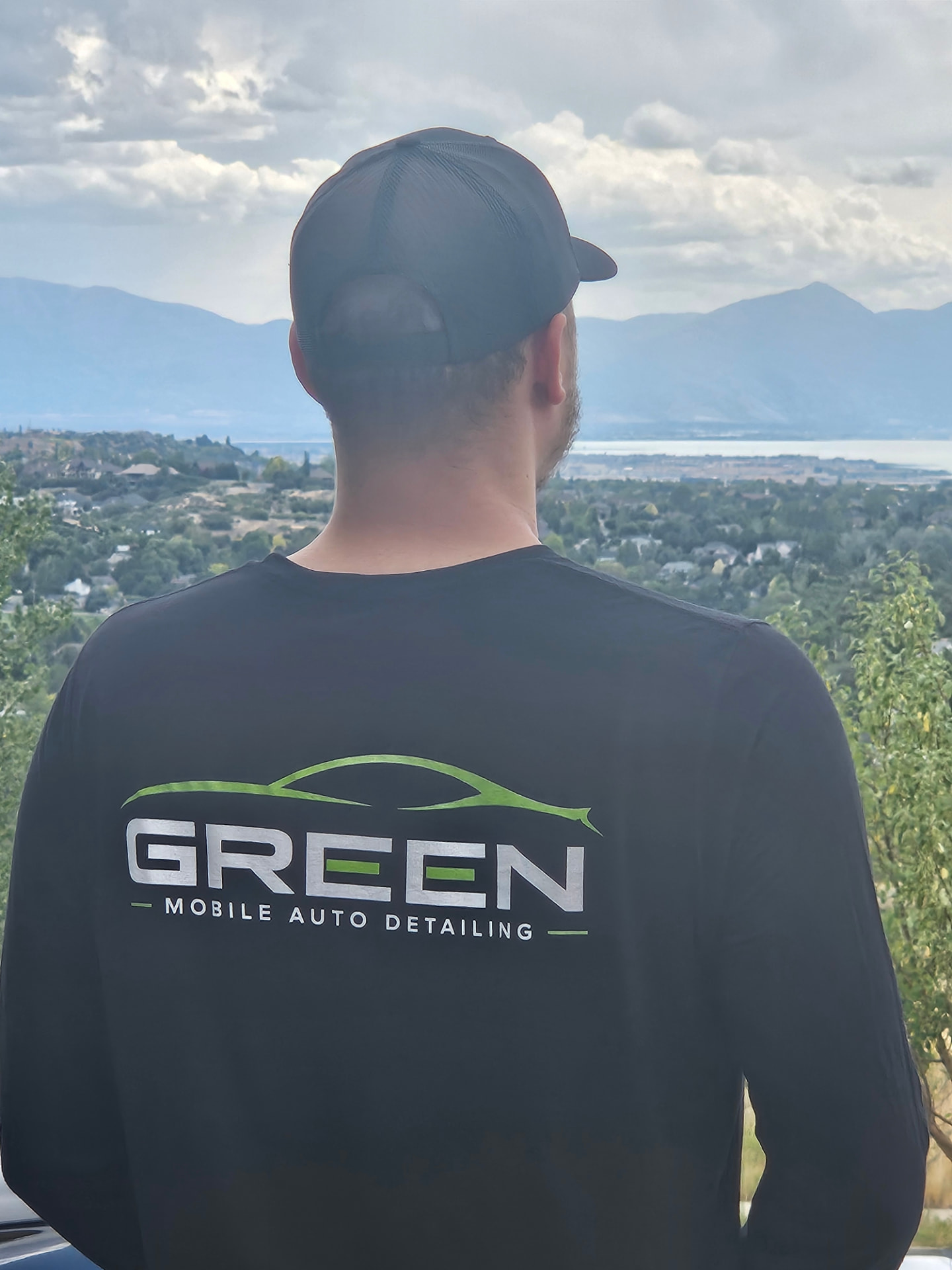Green Mobile Auto Detailing branded gear with the Utah County valley in the background
