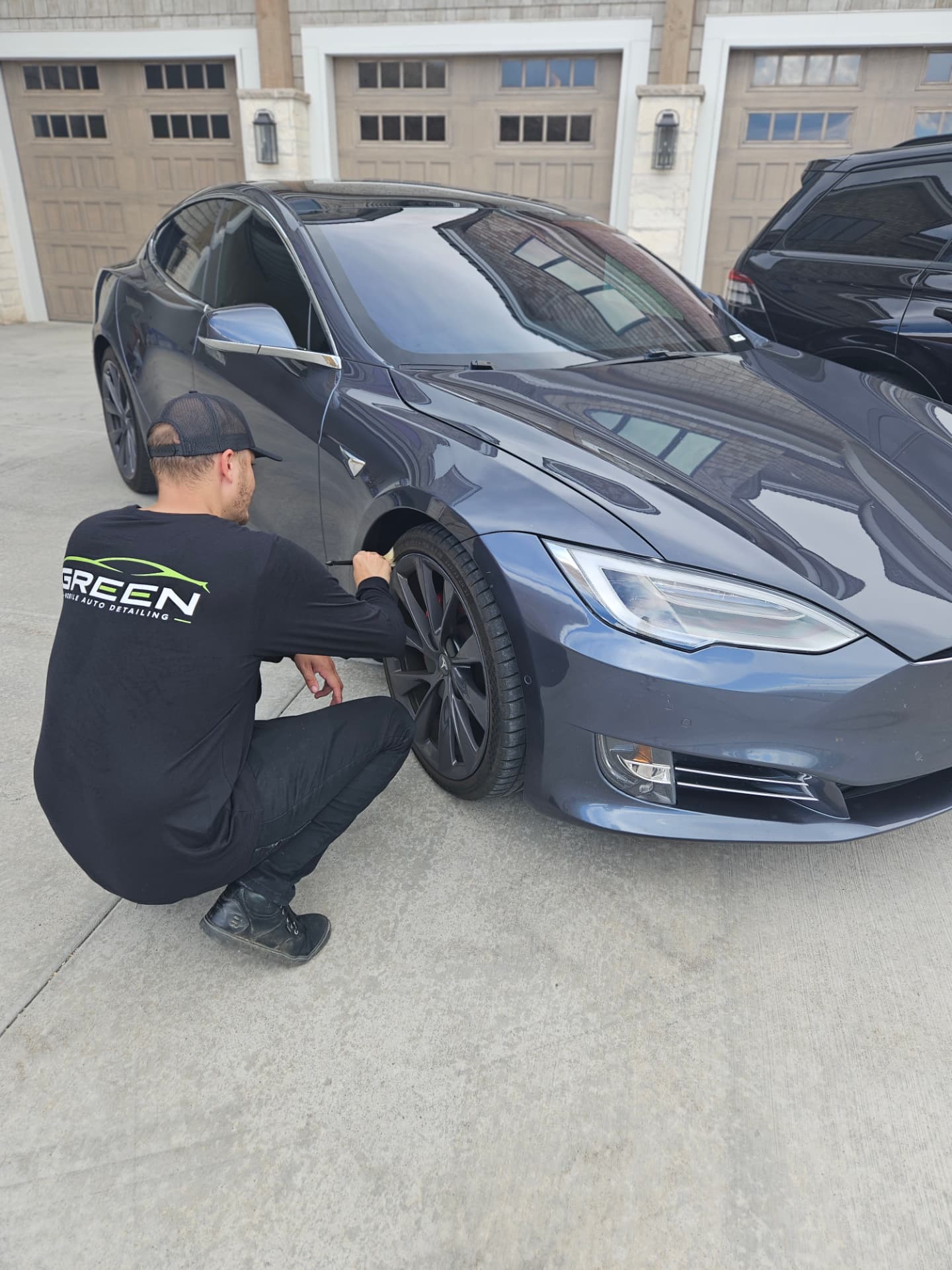 Conner hand-cleaning a wheel during a mobile detail